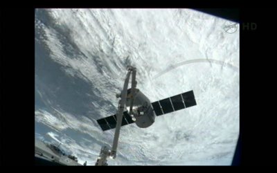 The Dragon spacecraft captured by the International Space Station's robotic arm (Photo NASA TV)