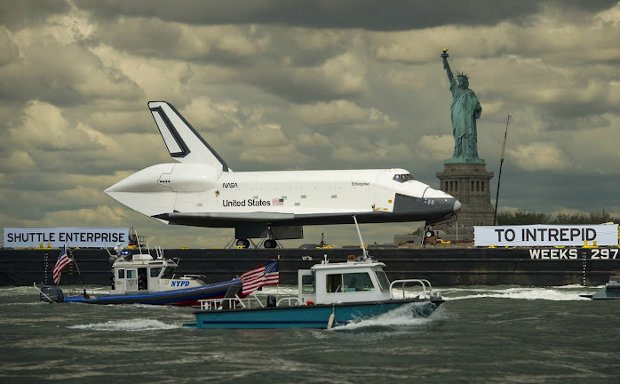 The space shuttle Enterprise atop a barge in the Hudson River on its way to the Intrepid Sea, Air and Space Museum (Photo NASA/Bill Ingalls)