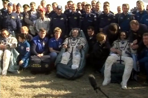 Koichi Wakata, Mikhail Tyurin and Rick Mastracchio assisted after their landing (Photo NASA TV)