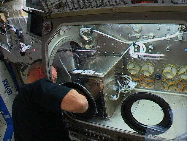 NASA astronaut Barry “Butch” Wilmore while installing the 3D printer on the Internationa Space Station (Image NASA TV)