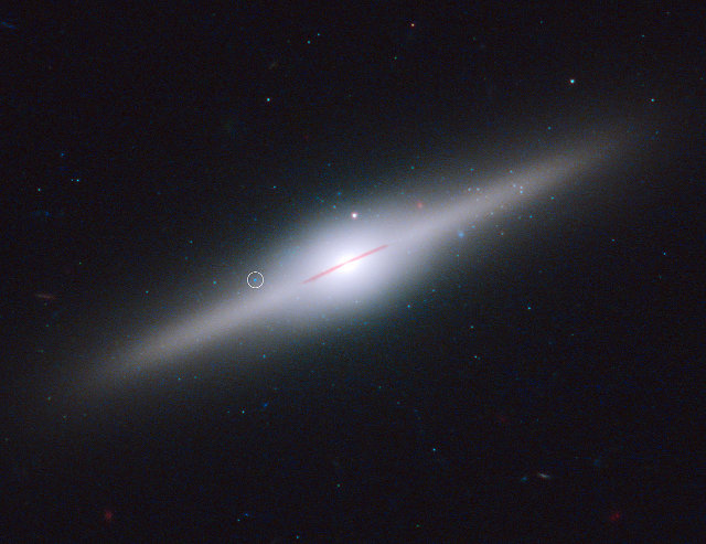 The galaxy ESO 243-49. The circle pinpoints the black hole XLX-1 (Image NASA, ESA, and S. Farrell (University of Sydney, Australia and University of Leicester, UK))