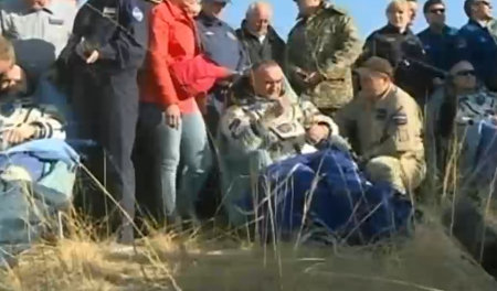 The Russian cosmonauts Oleg Artemyev and Alexander Skvortsov and the American astronaut Steve Swanson assisted after they landed in the Soyuz TMA-12M spacecraft (Image NASA TV)