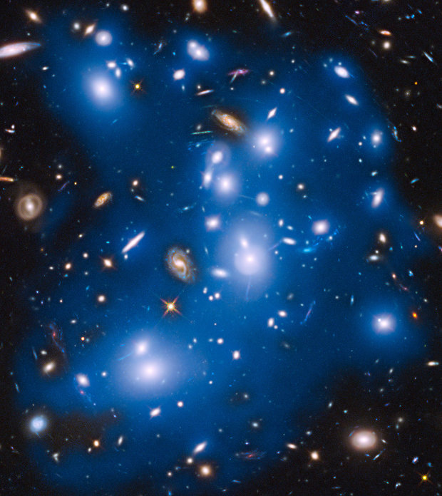 The galaxy cluster Abell 2744, also known as Pandora's Cluster. The starlight is colored blue (Image NASA/ESA/IAC/HFF Team, STScI)