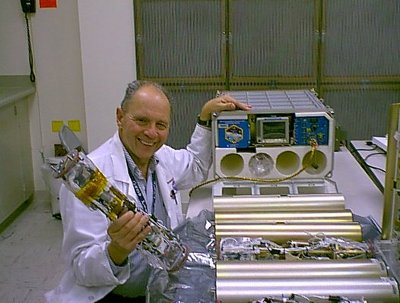 Dr. Dennis Morrison with the Microencapsulation Electrostatic Processing System used on the International Space Station (Photo NASA)
